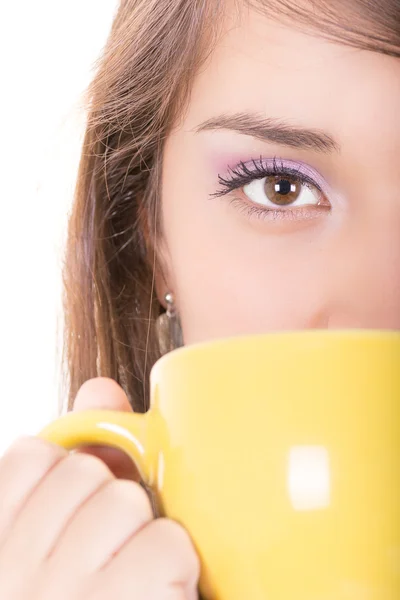 Closeup of yellow cup and a woman face — Stock Photo, Image
