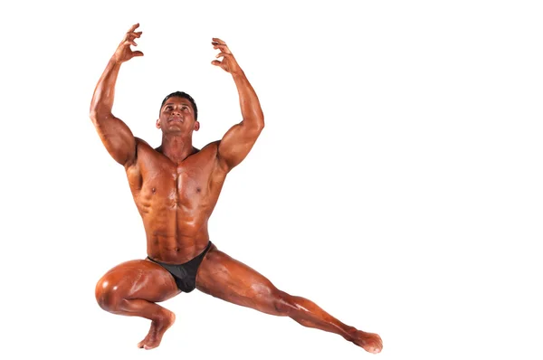 Musculado modelo masculino posando em estúdio em um fundo leve — Fotografia de Stock