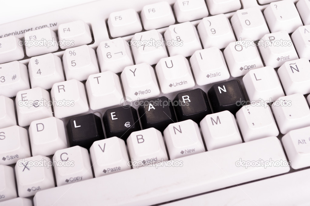 Word Learn written with black keys on computer keyboard.