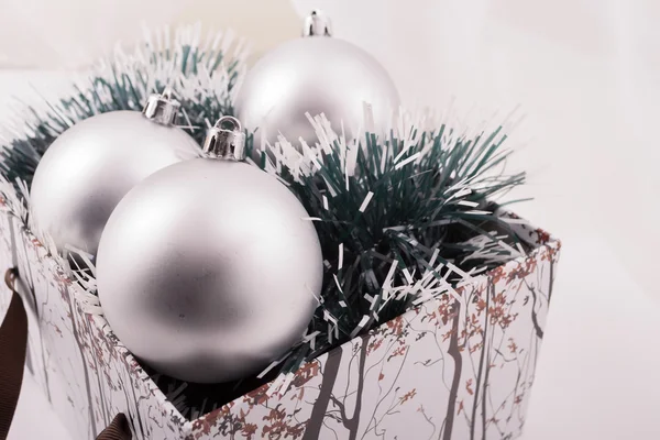 Silver Christmas gift with ornaments — Stock Photo, Image