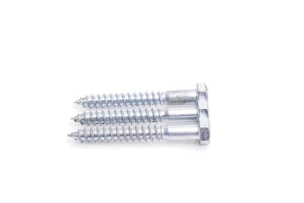 Screws located on a white background — Stock Photo, Image