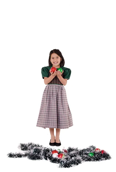 Adorable girl wearing a green Christmas holiday dress with ornaments — Stock Photo, Image