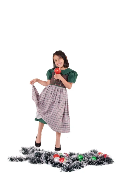 Adorable girl wearing a green Christmas holiday dress with ornaments — Stock Photo, Image