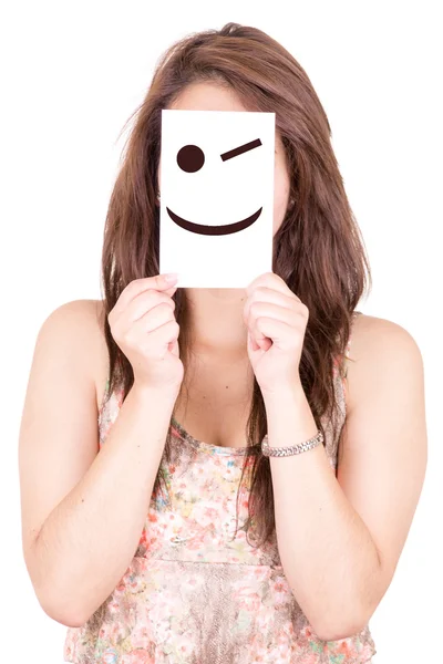Hübsche junge Frau mit einem augenzwinkernden glücklichen Emoticon — Stockfoto