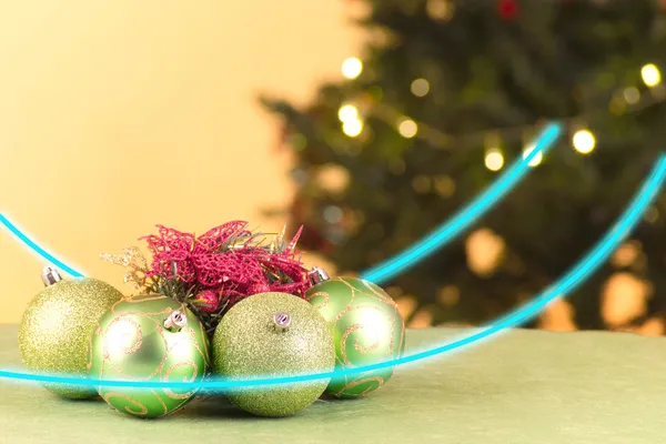 Green Christmas balls with tree and lights — Stock Photo, Image