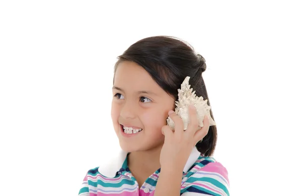Beautiful hispanic girl listening shell sounds — Stock Photo, Image