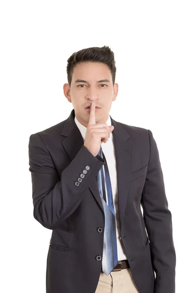 Empresario hispano poniendo dedos en los labios, shh — Foto de Stock