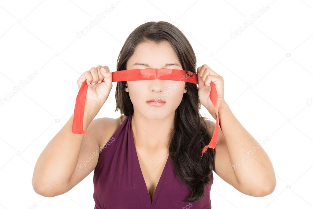 Hispanic woman covering her eyes with a blindfold