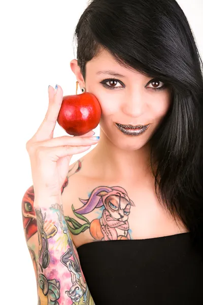 Portrait of caucasian young woman with apple and tattoos — Stock Photo, Image