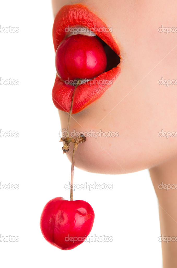 Young woman's mouth with red cherries  over white background