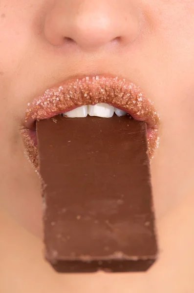 Closeup of a woman eating chocolate — Stock Photo, Image
