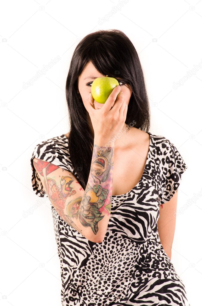 Happy grunge woman with tattoos, and apple, isolated on white