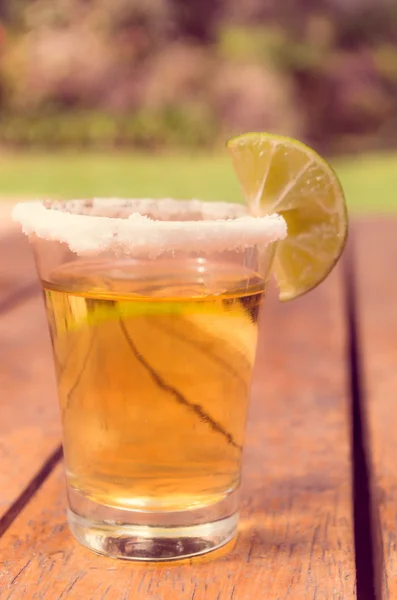 Gold tequila shot with lemon — Stock Photo, Image