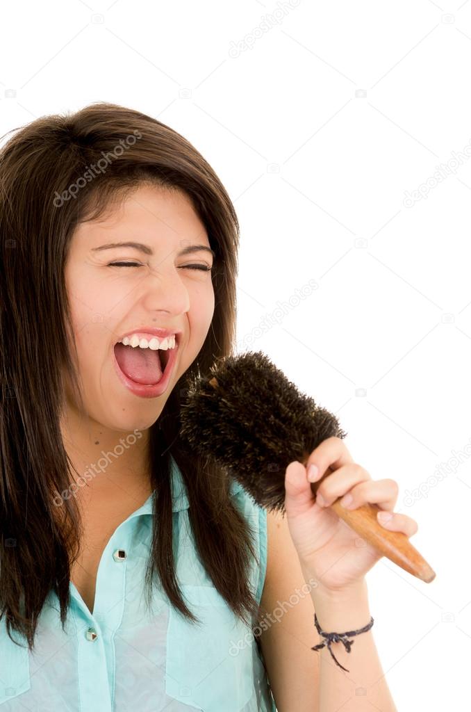 Woman singing into brush