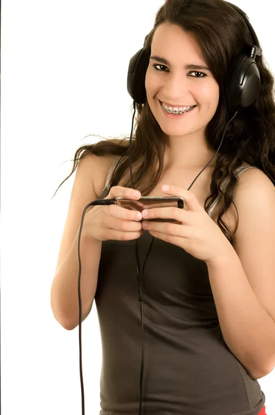 Young adult hispanic girl is listening to the music — Stock Photo, Image