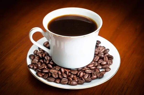 Coffee cup with seeds — Stock Photo, Image