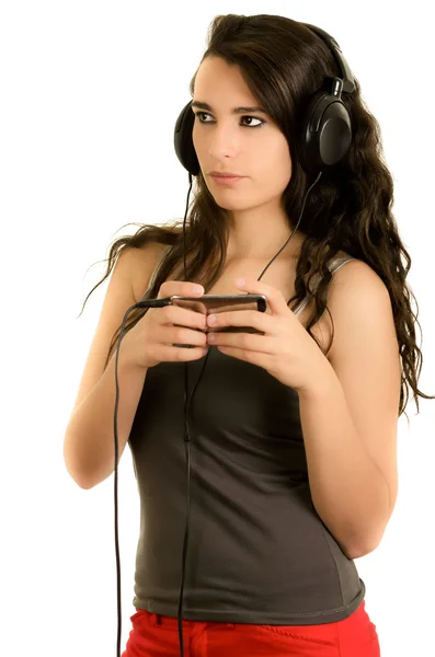 Young adult hispanic girl is listening to the music — Stock Photo, Image