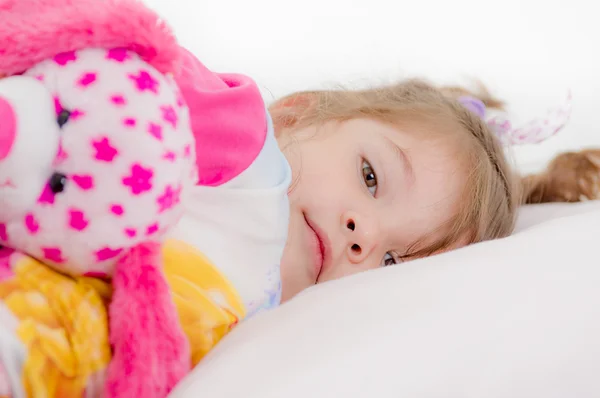 Adorable little girl going to sleep in the bed — Stock Photo, Image