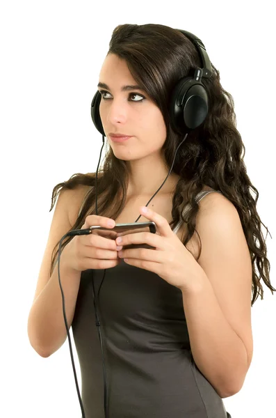 Young adult hispanic girl is listening to the music — Stock Photo, Image