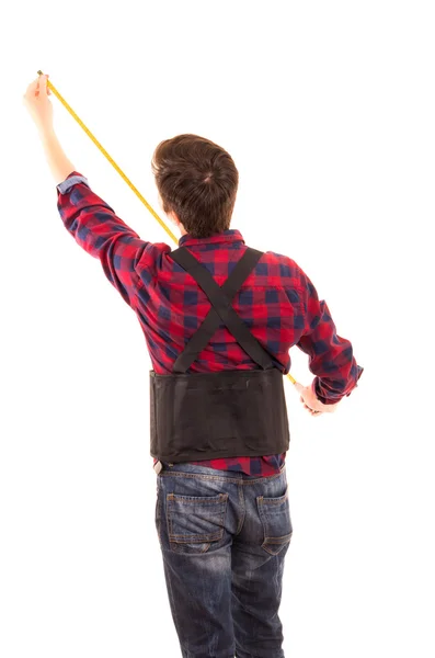 Hombre con cinta métrica handyman sobre fondo blanco —  Fotos de Stock