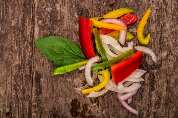 Diced peppers on a wood backgroiund — Stock Photo, Image