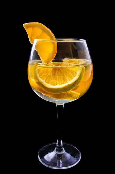 Orange slices on a glass on wine with dark background — Stock Photo, Image