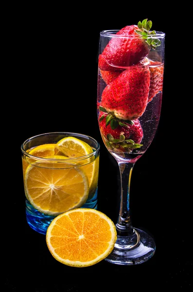 Oranges and strawberries on a glass — Stock Photo, Image