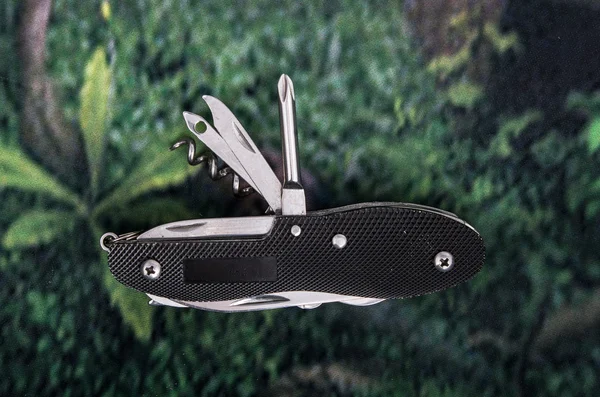 Black swiss army knife multitool — Stock Photo, Image