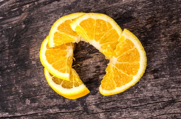 Orange slices on wood background — Stock Photo, Image