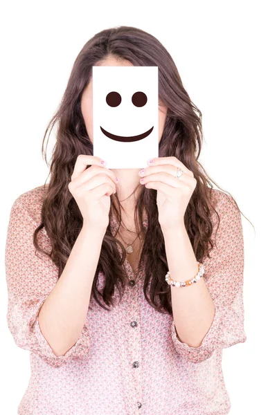 Kvinna med smiley på ett papper i hennes ansikte — Stockfoto