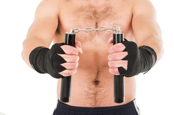 Kampsport fighter innehar svart nunchaku med händerna — Stockfoto