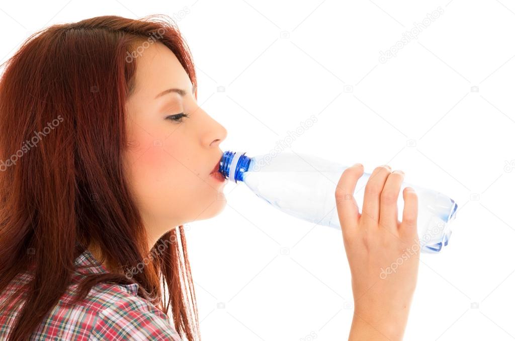 Beautiful young girl drinking water