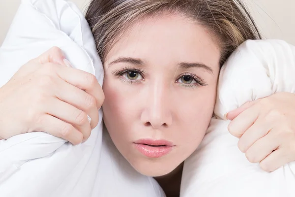 Tired young girl lying in bed — Stock Photo, Image