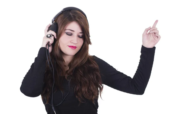 Pretty young girl wearing headphones listening to music and dancing — Stock Photo, Image