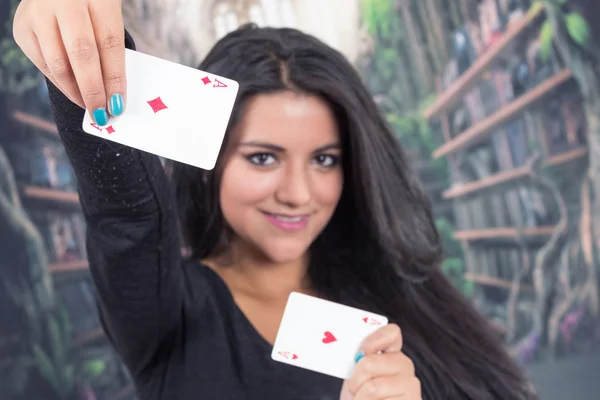 Beautiful young girl holding deck of cards — Stock Photo, Image