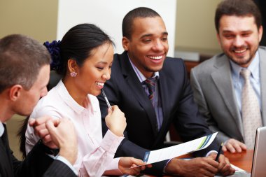 Multi ethnic business team at a meeting clipart