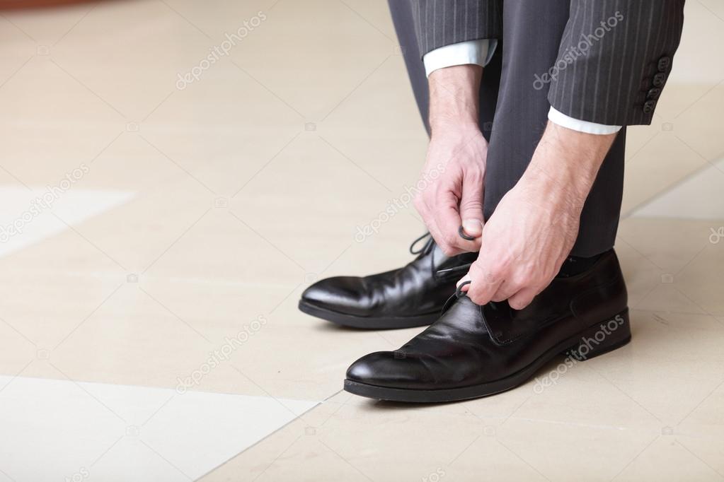 Man ties his shoes