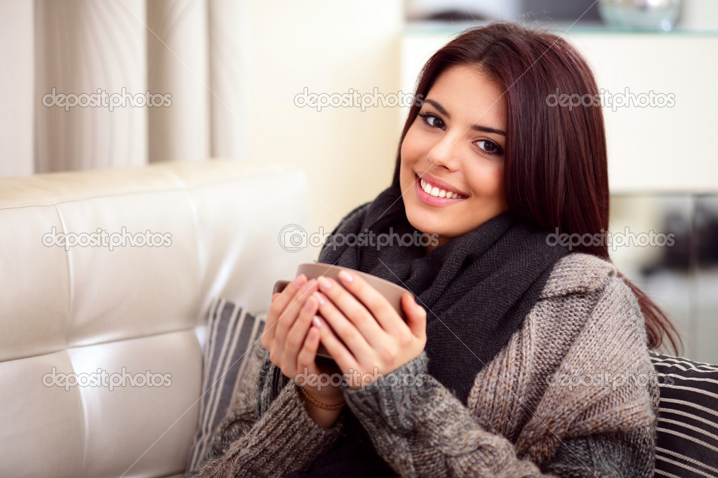 Portrait of a young beautiful woman on sofa