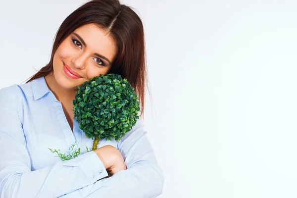 Young beautiful woman hugging small green tree — Stock Photo, Image