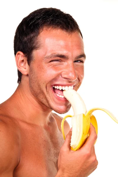 Young man eating banana — Stock Photo, Image