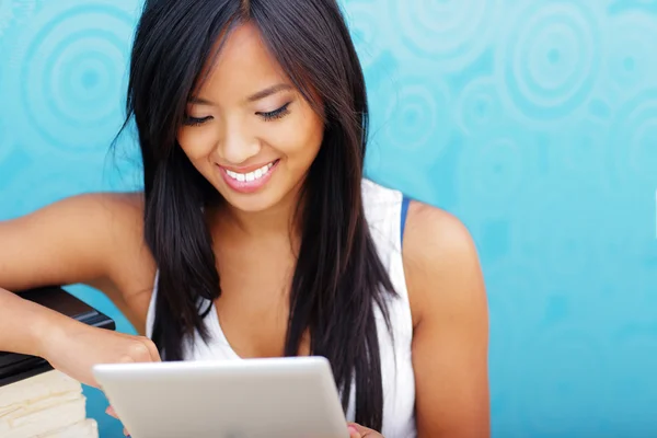 Young happy asian woman using tablet at home — Stock Photo, Image