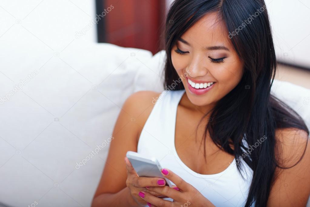 Asian woman text messaging with her smart phone