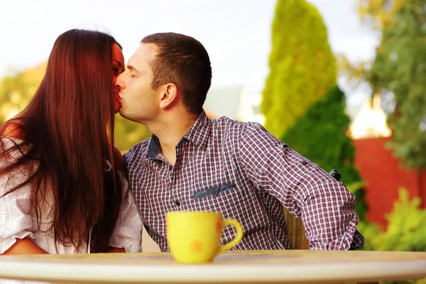 Romantic couple kissing in cafe — Stock Photo, Image