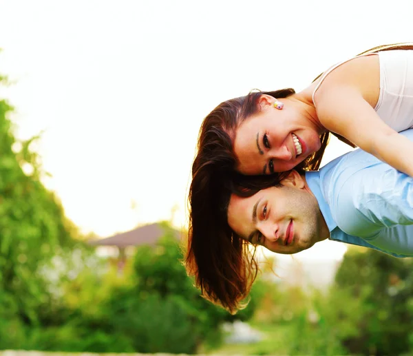 Happy woman jumped on man's back — Stock Photo, Image