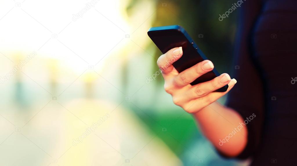 Female hand using a smart phone