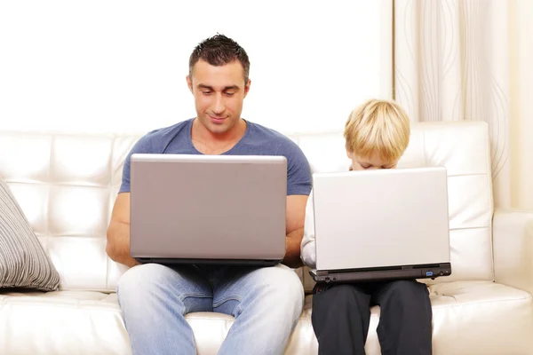 Father and son working on computers — Stock Photo, Image