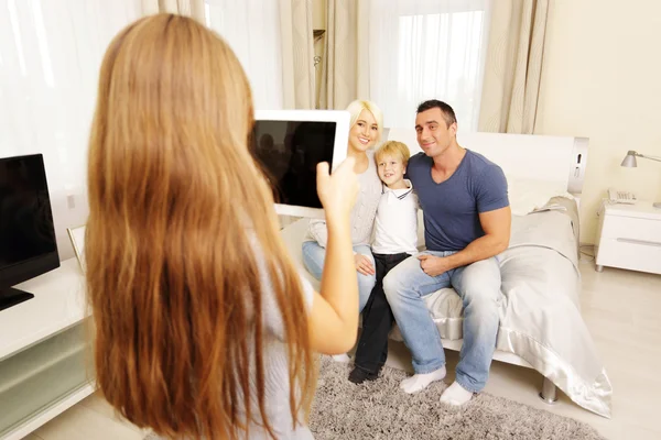 Girl making photo of family — Stock Photo, Image