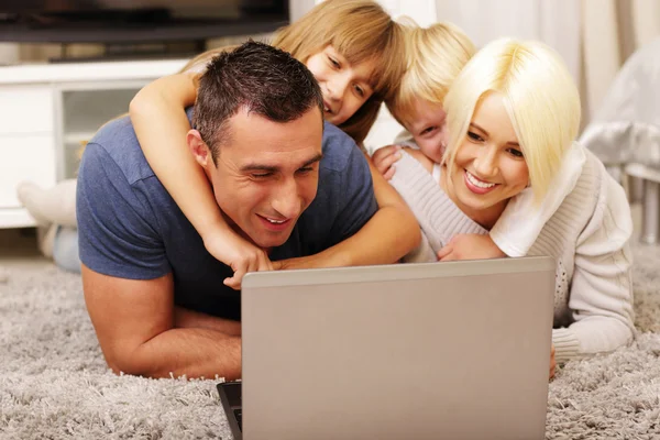 Happy family lying at home — Stock Photo, Image