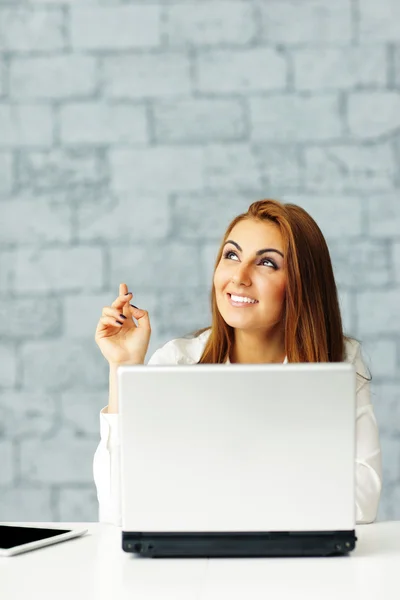 Businesswoman with laptop pointing up — Stock Photo, Image