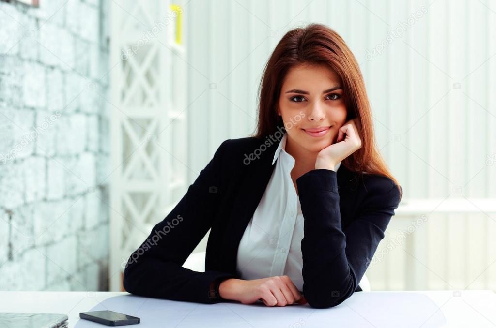 Businesswoman sitting at the table on her workplace